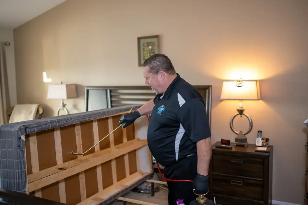 Bed Bugs Arizona treating a bed frame by hand