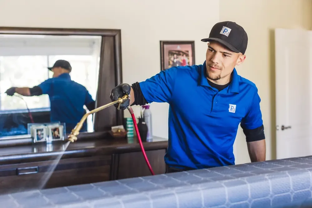 Bed Bugs Arizona treating a bed frame by hand