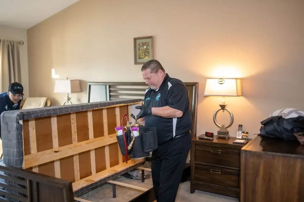 Bed Bugs Arizona treating a bed frame by hand