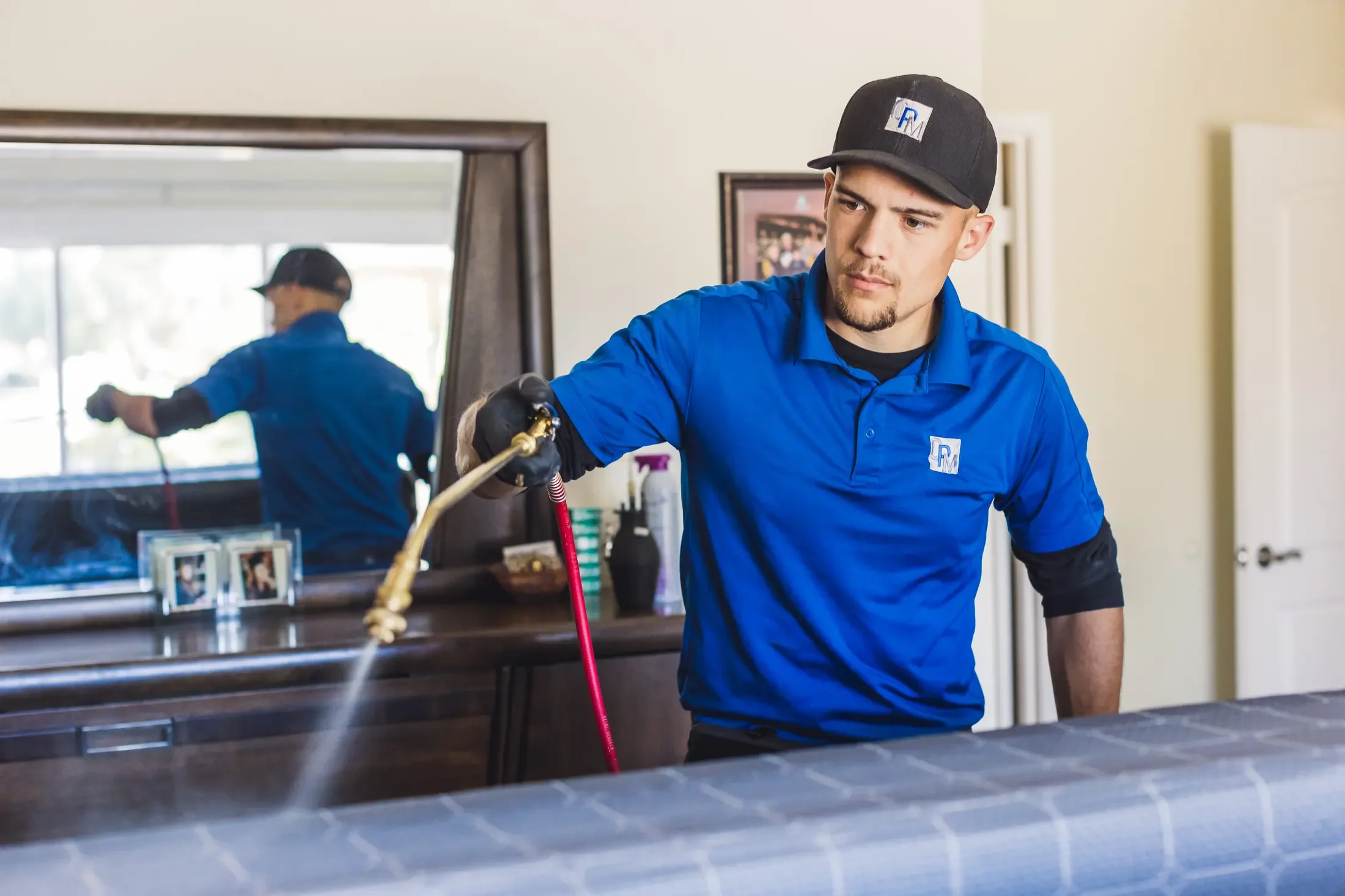 John Taylor applying the Pro-Treat Plus bed bug treatment in a Phoenix bedroom