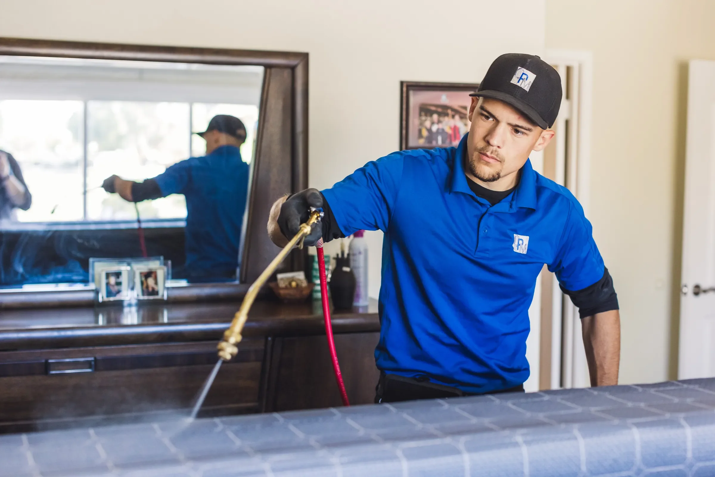 Bed Bugs Arizona treating a bedroom by hand with a sprayer