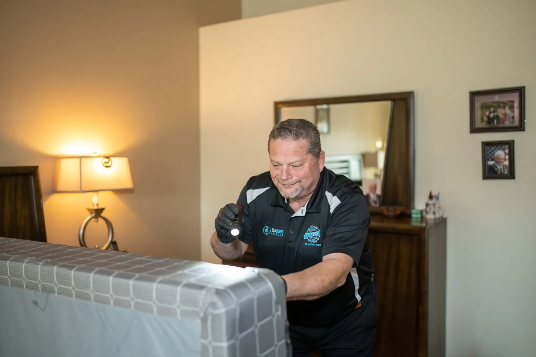 Bed bug inspection of a bed with a flashlight, Free In-Home Bed Bug Inspection in Phoenix, AZ