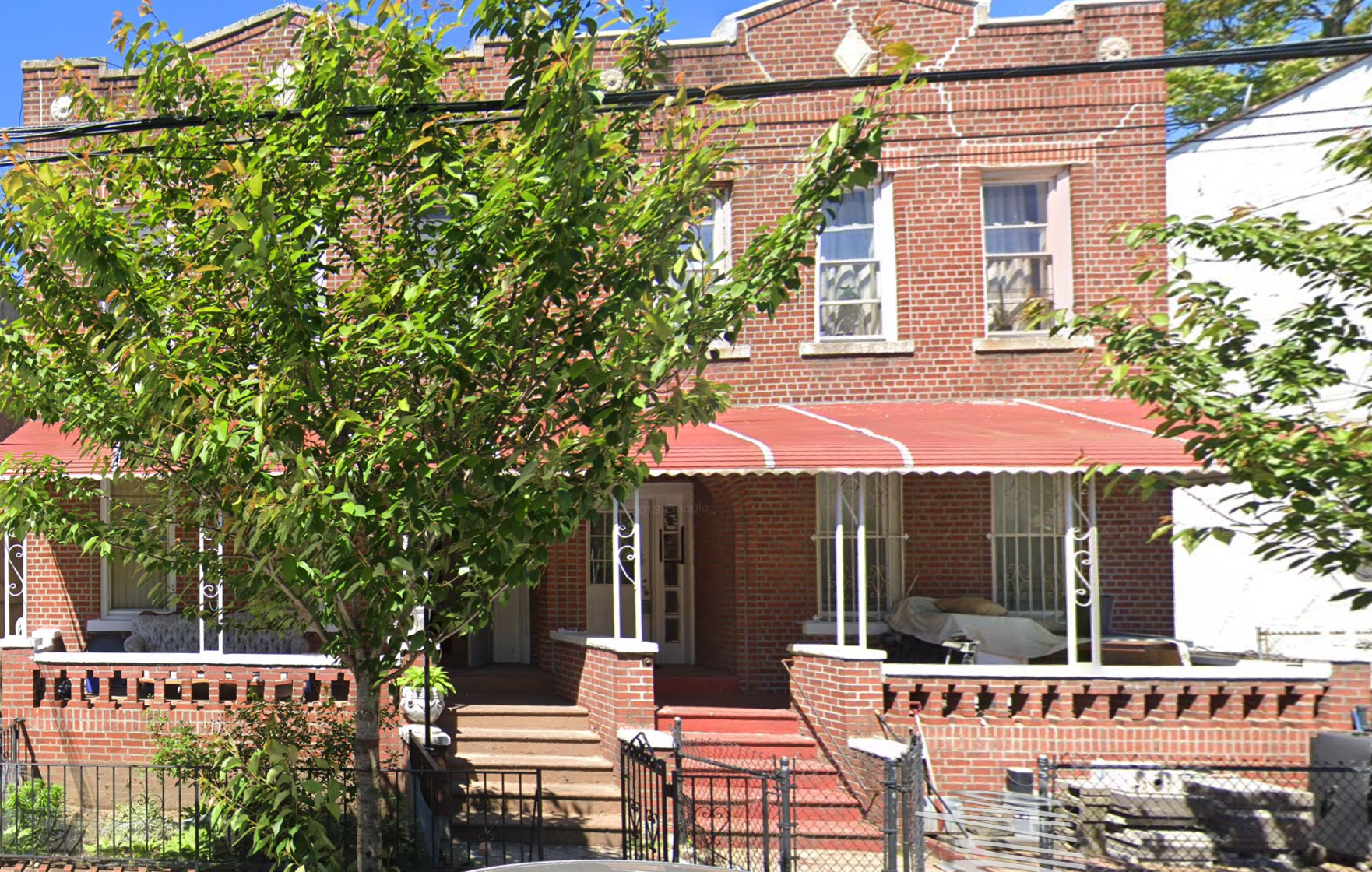 E 52nd Street property in Brooklyn, a brick residential building with red awnings and front stoops