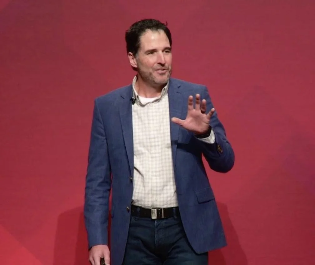 Carlos Hidalgo speaking on a TEDx stage