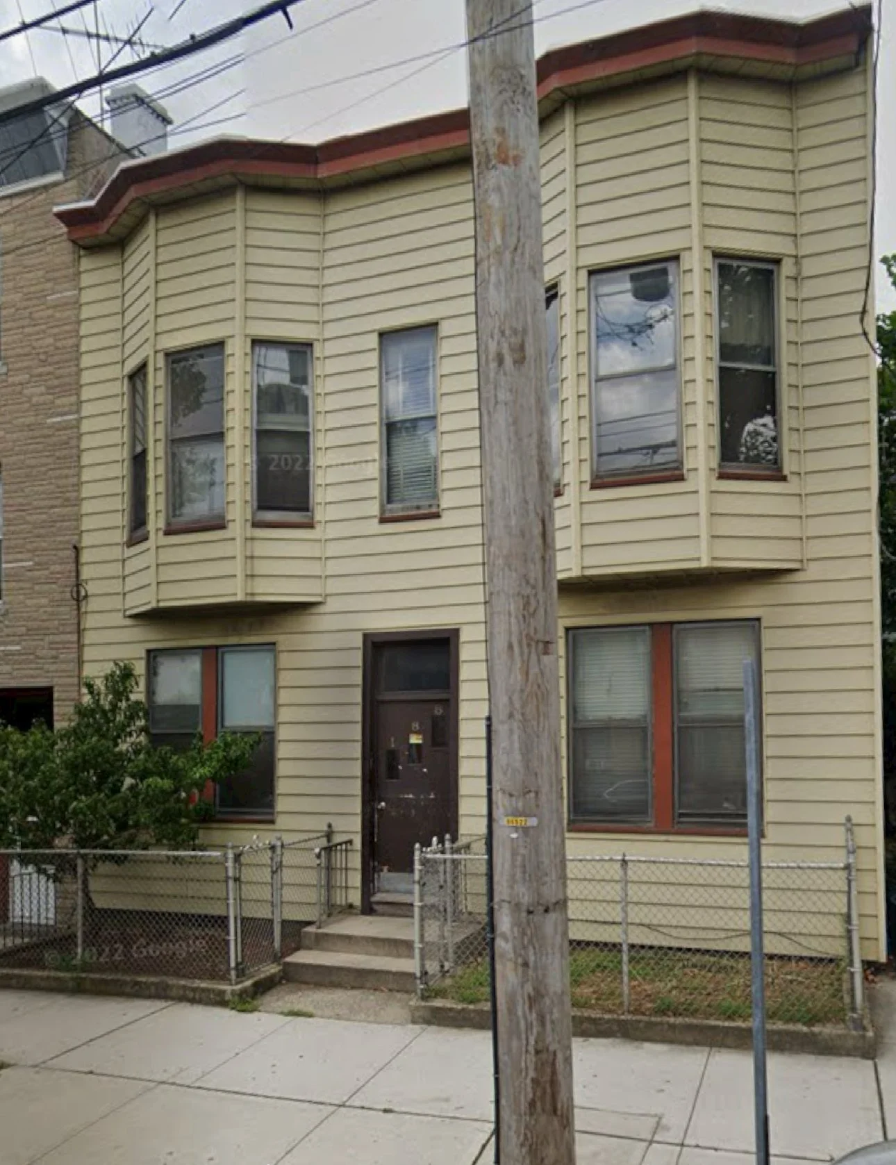 188 Manhattan Ave — exterior of the two-family home before renovation