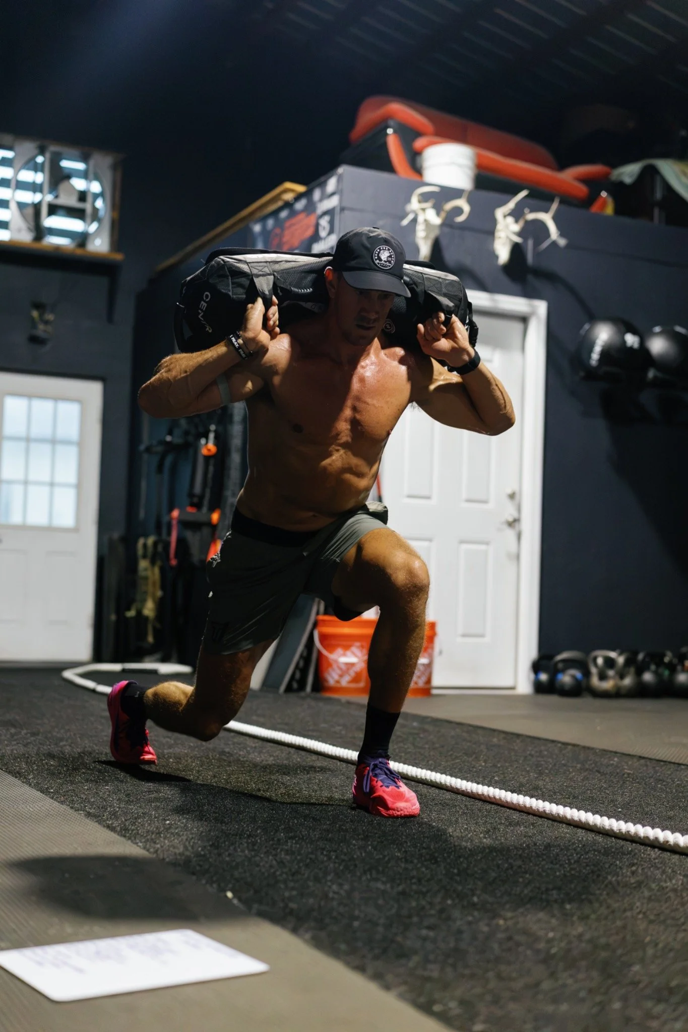 Athlete training with a weighted sandbag