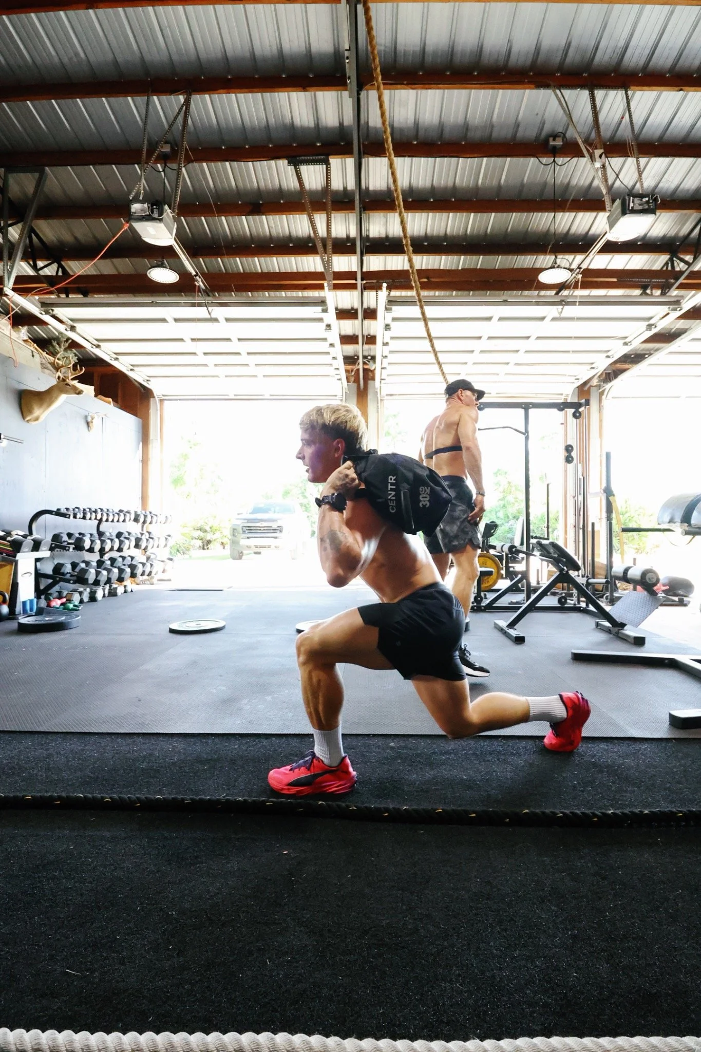 Athlete performing a weighted lunge in a gym
