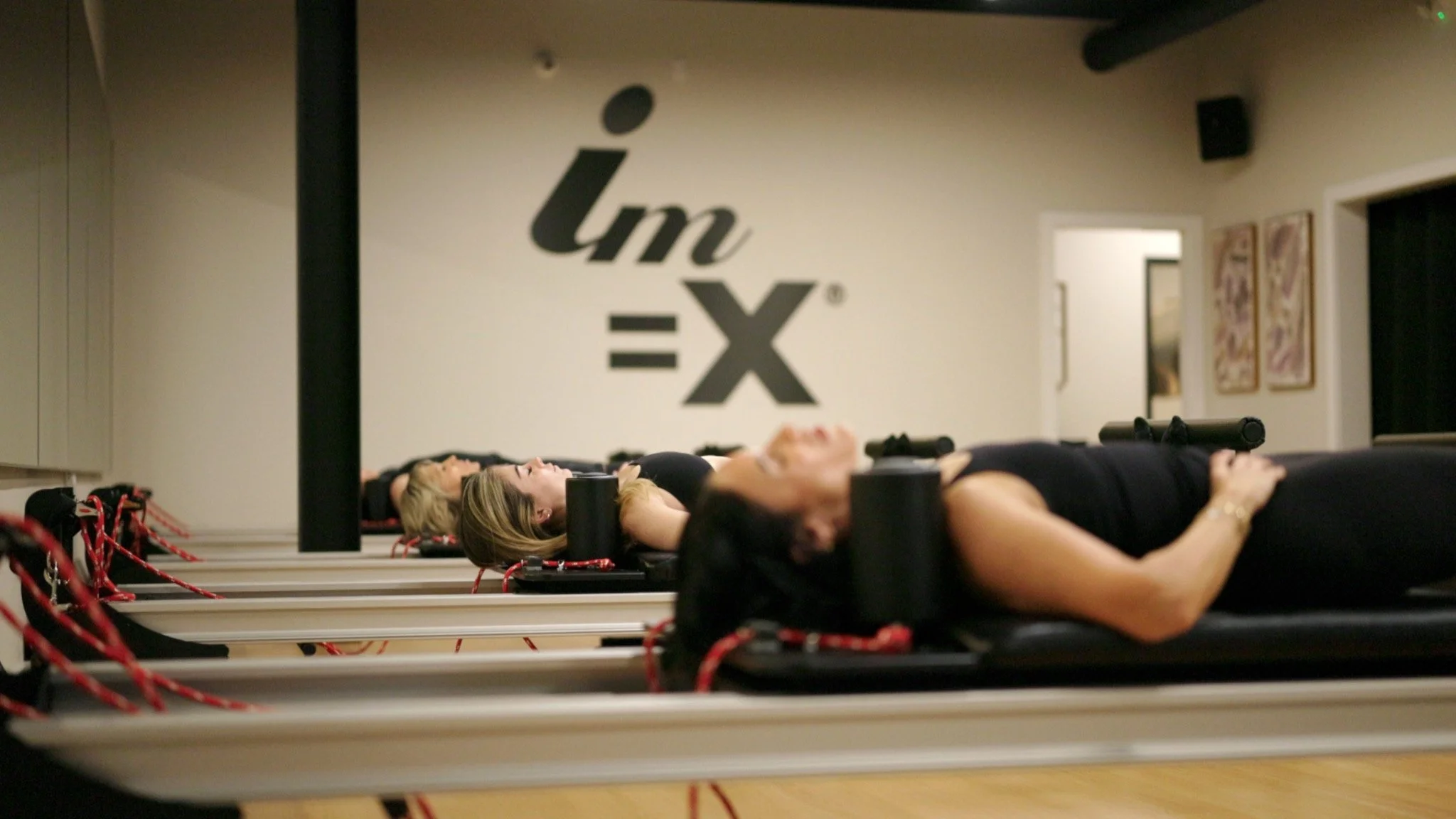 Pilates participants training on reformers