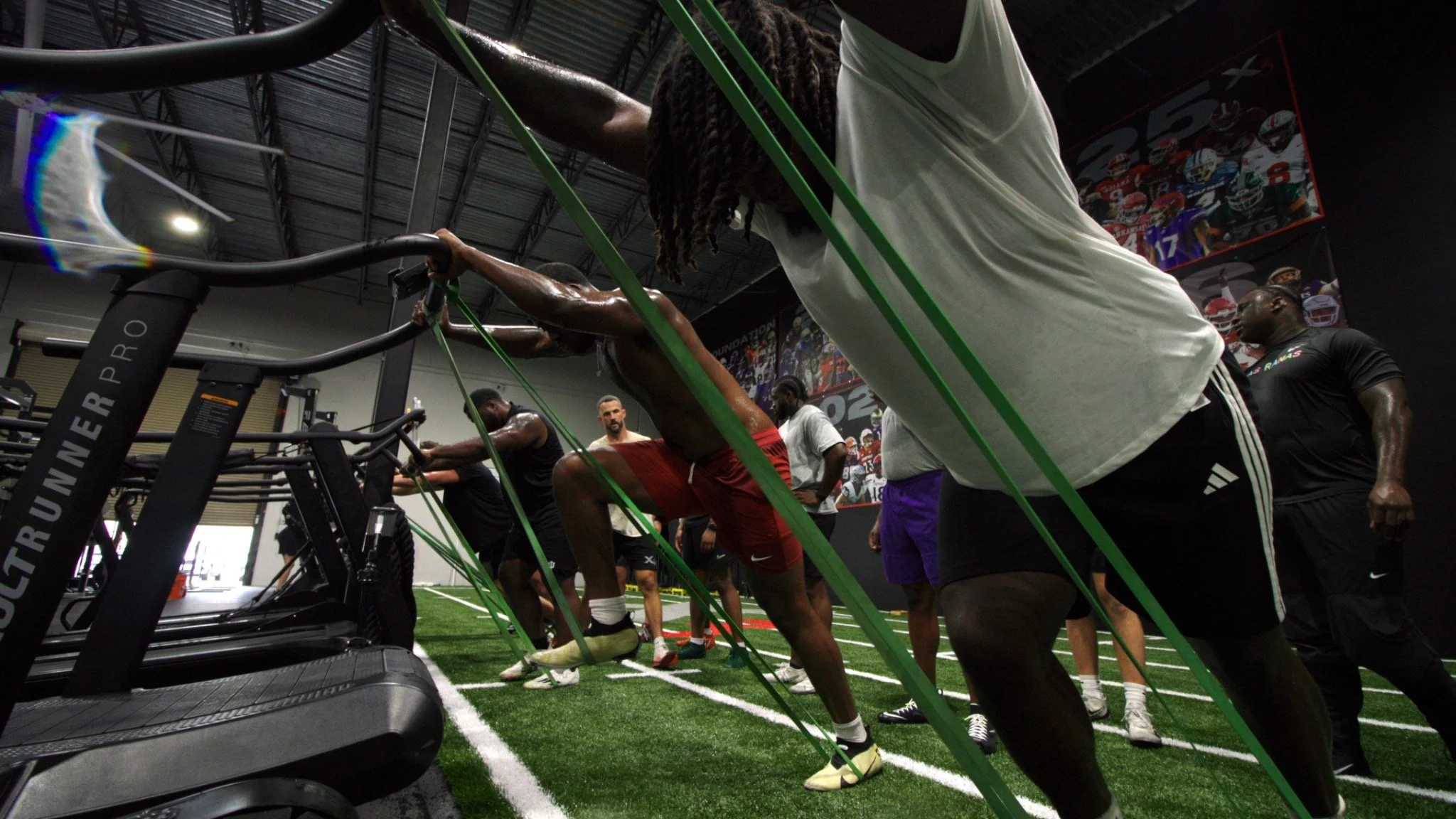 Athletes performing resisted treadmill training