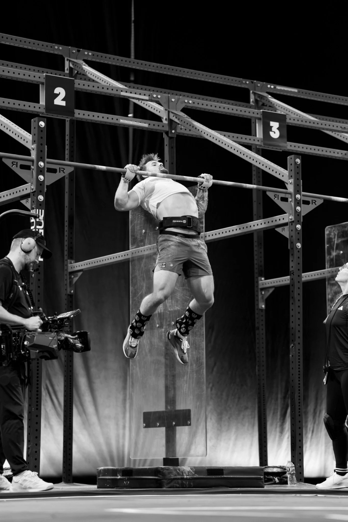 Athlete performing a hanging movement on a gym rig