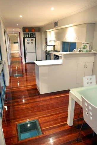 Kitchen and dining with jarrah floors and a glass floor panel
