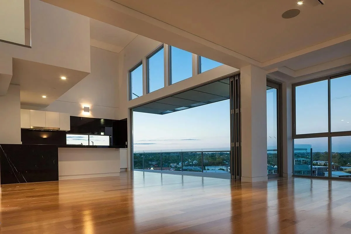 Double-height living space with folding glass doors