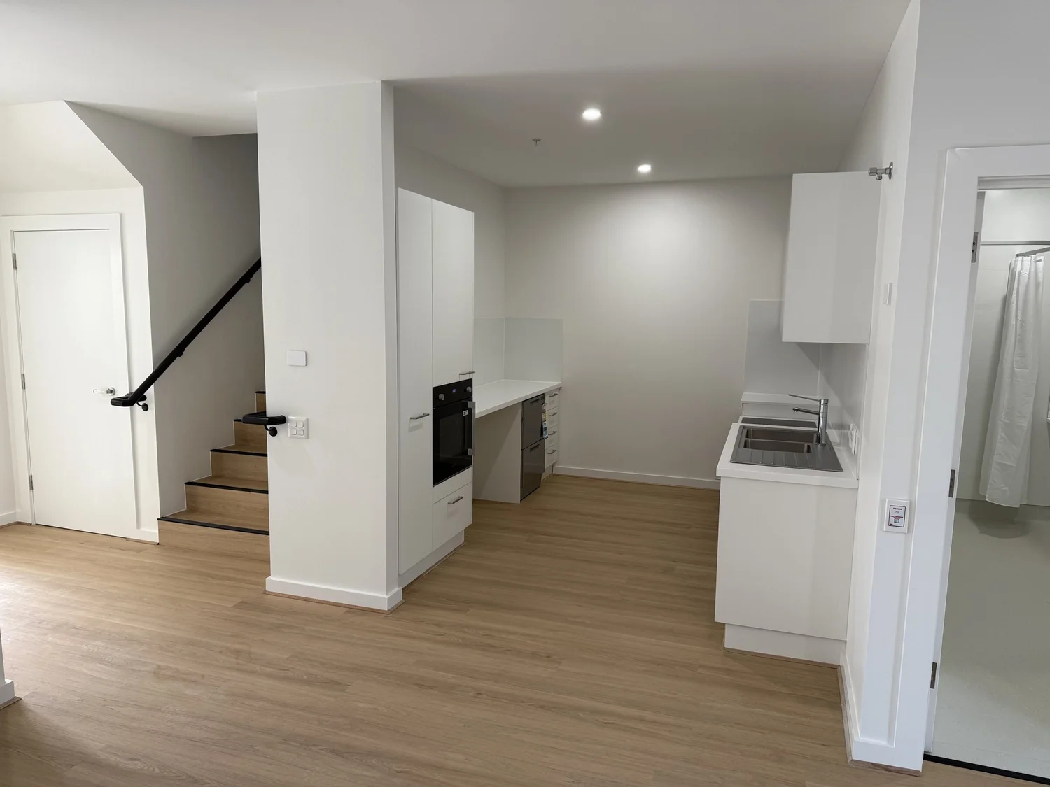 The ground floor: stair, kitchen and the accessible bathroom side by side off one open space