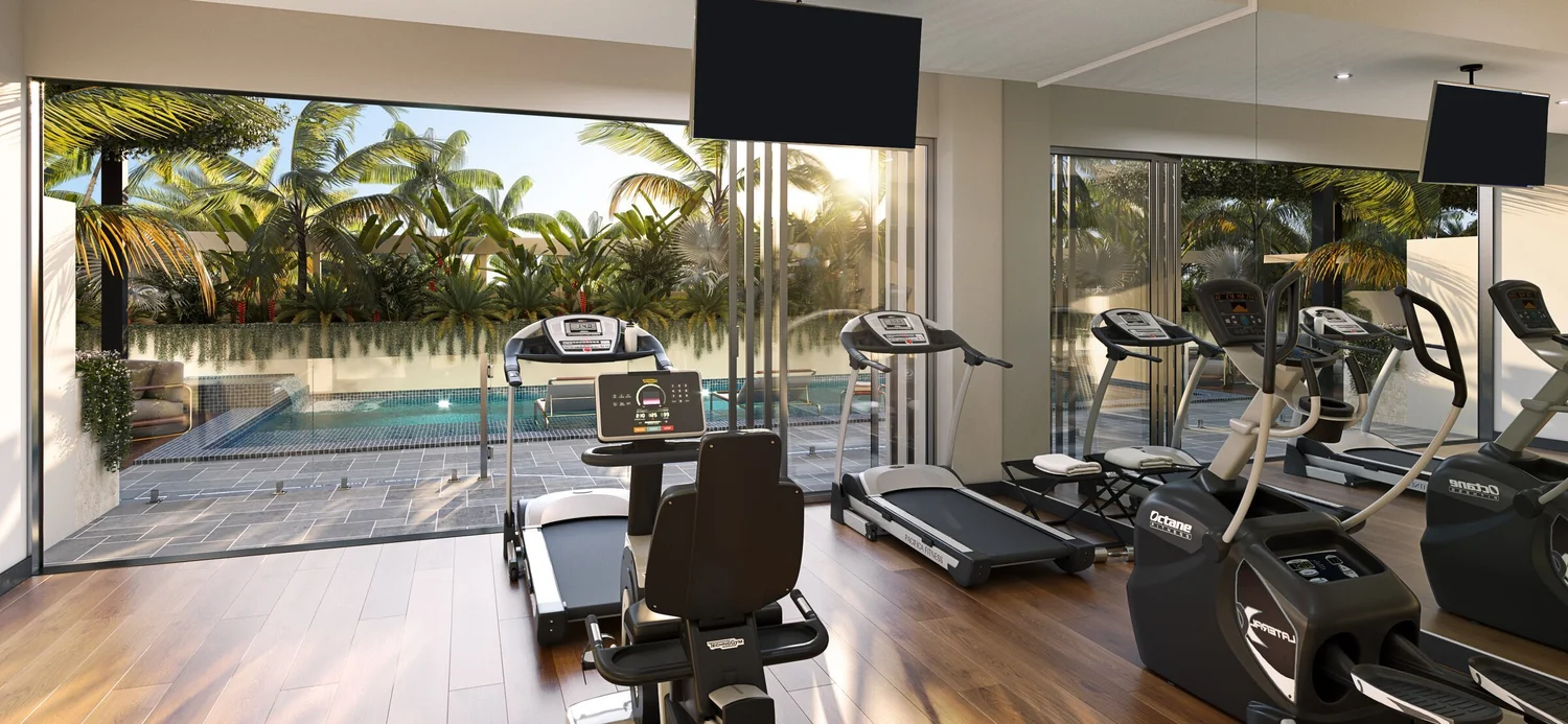 The residents' gym, opening through full-height glass to the pool and tropical planting