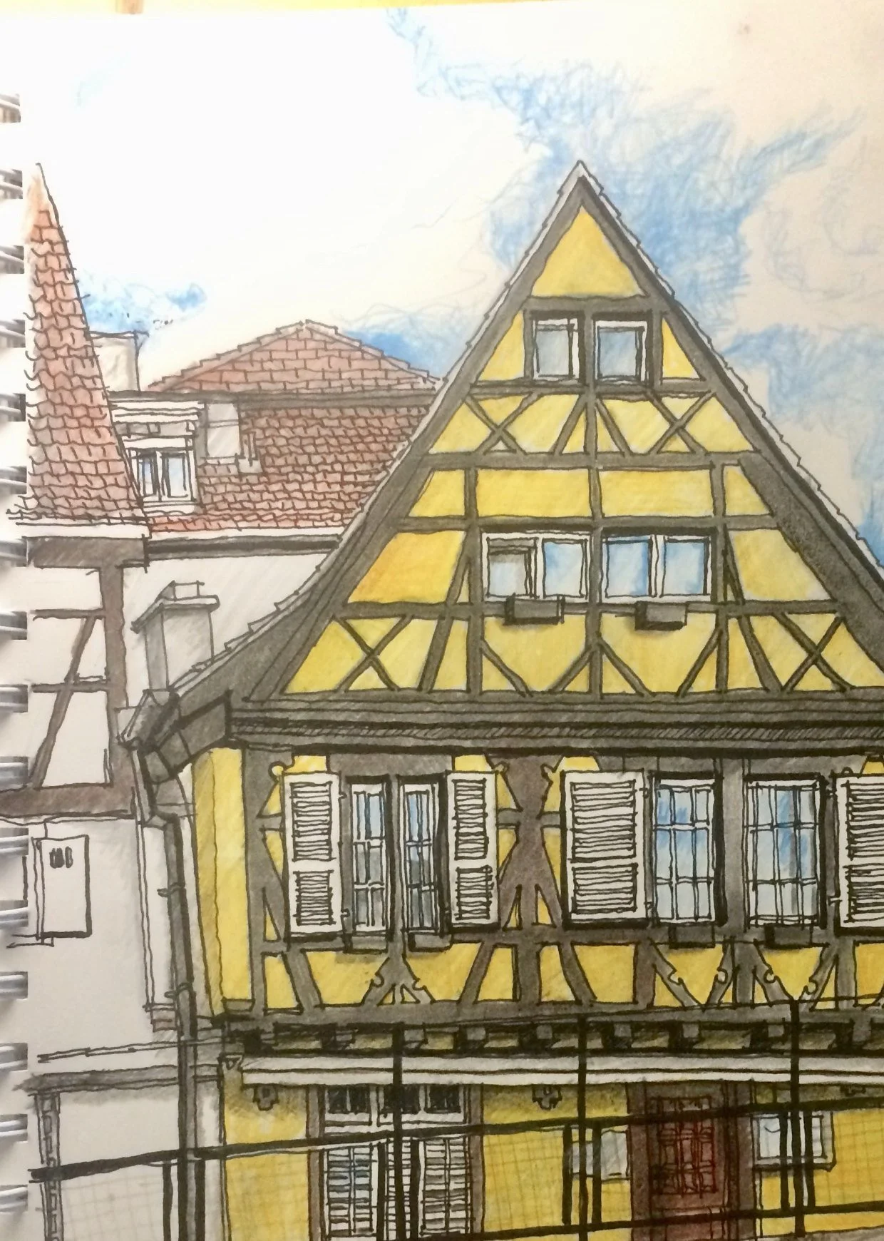 Sketchbook drawing of a yellow half-timbered house