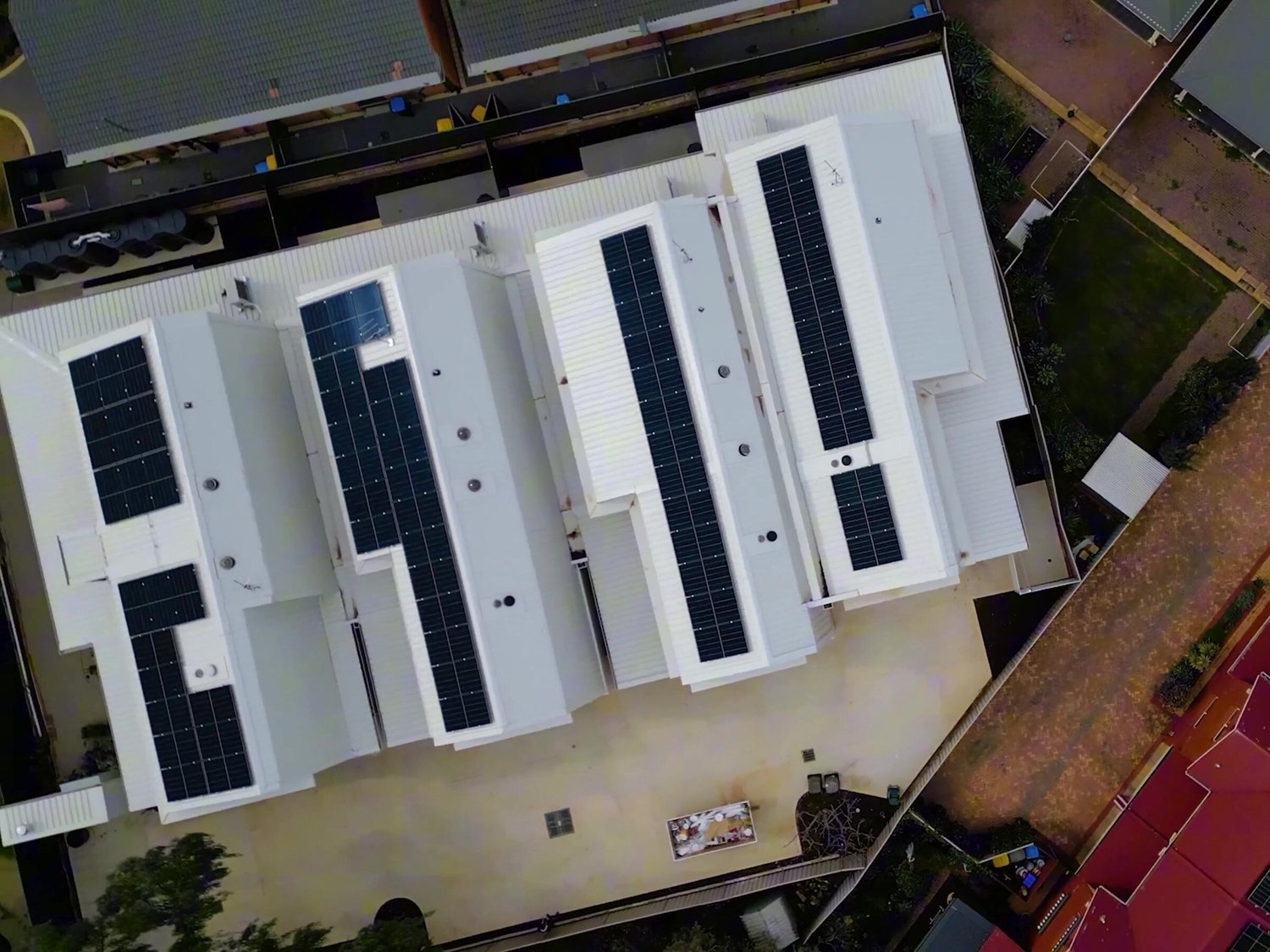 The four townhouse roofs from directly above, each with its own solar panels