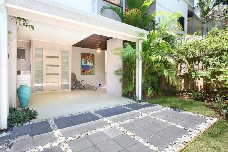 Covered entry patio with stepping-stone paving and planting