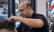 Brahim cutting a client’s hair at Cambridge Barber Shop