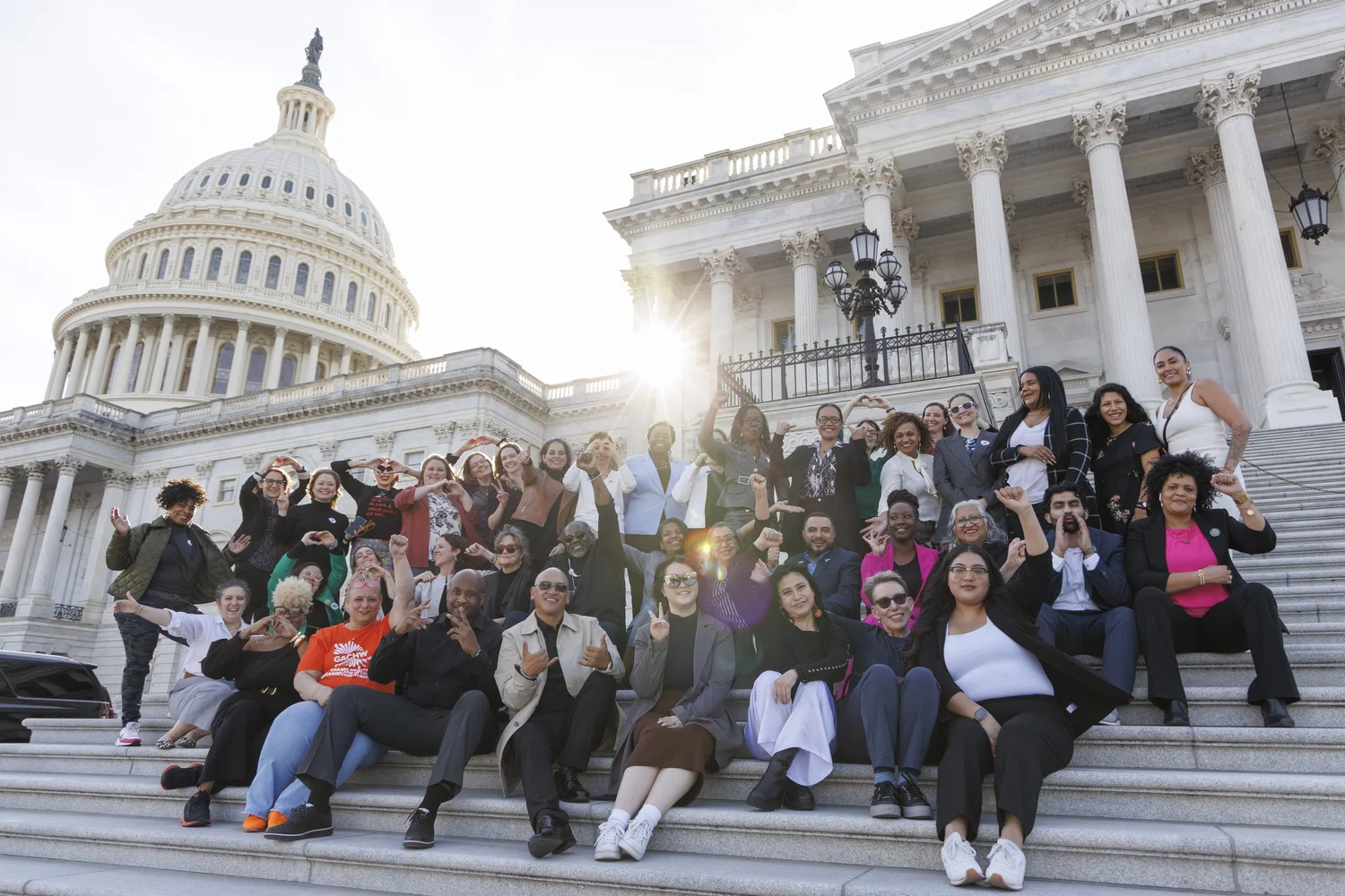 CHWs and allies seated on the Capitol steps for CHW Hill Day 2024