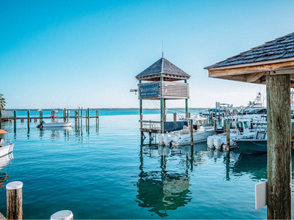 Boats at a dock over clear turquoise water