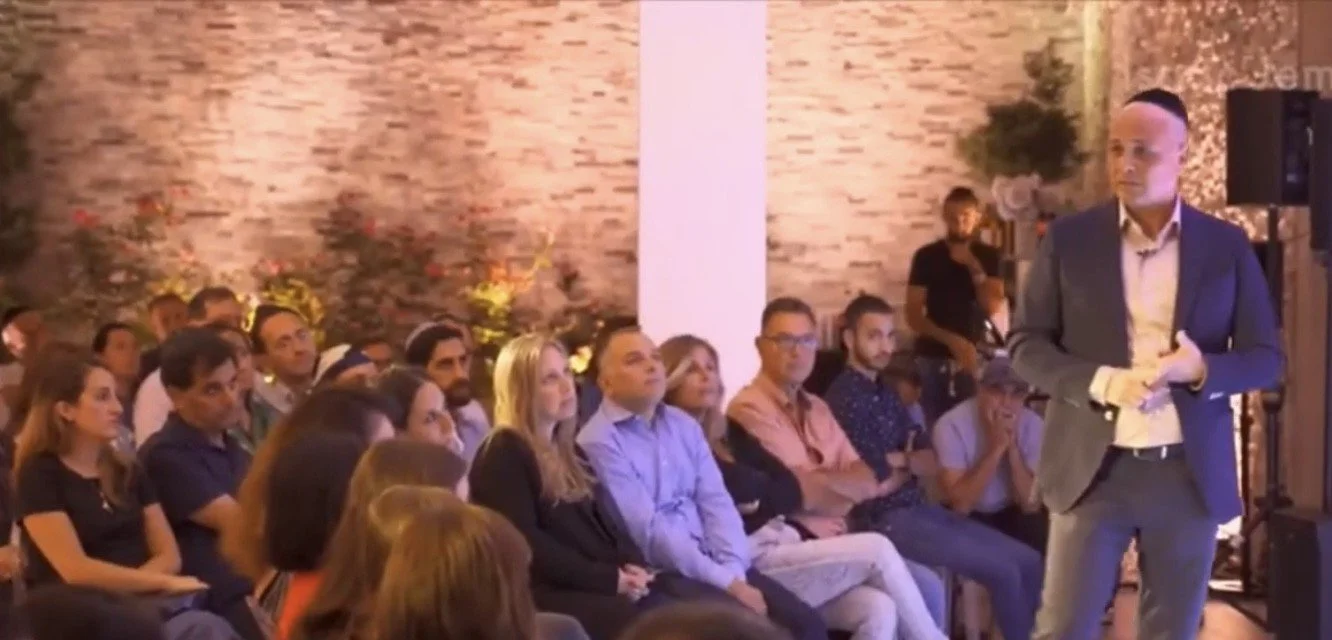 Isaac teaching a full room of couples at a workshop