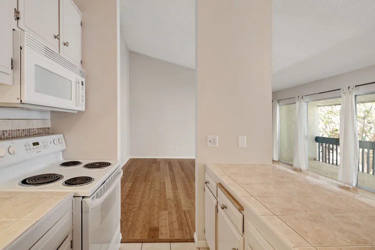 Kitchen counter and range looking through to the living room