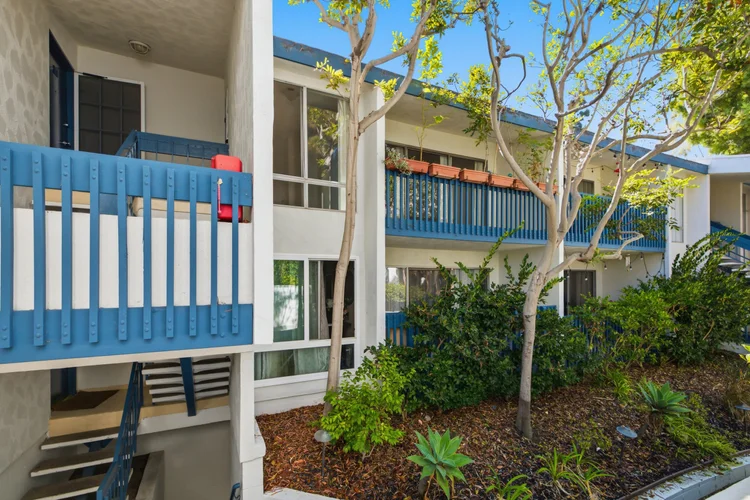 Upper-level balconies and stairs above landscaping