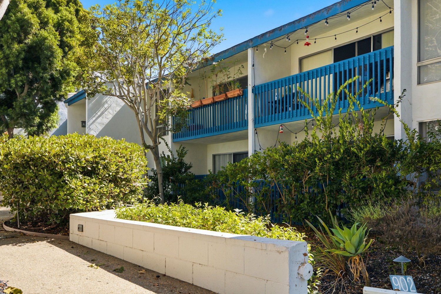 Brookside Village buildings with blue balcony railings and landscaping