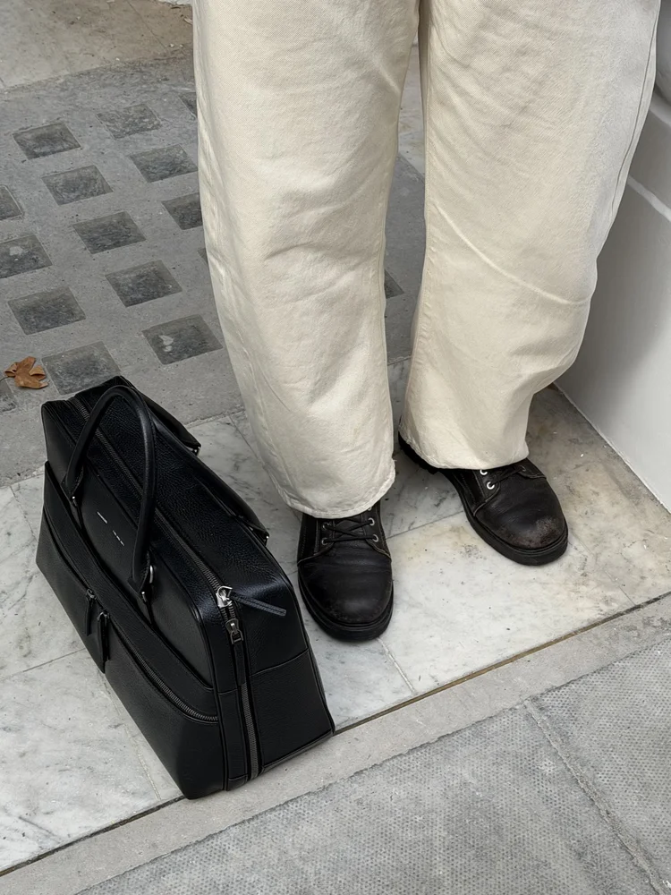 Cream trousers, loafers and holdall