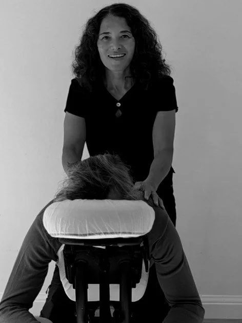 Estuary therapist giving a regular on-site chair massage at an office
