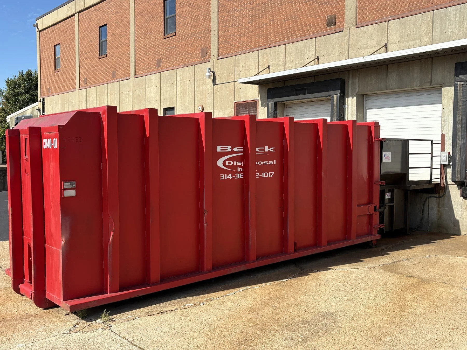 Alternate view of Beck compactor equipment and receiving container at a loading dock