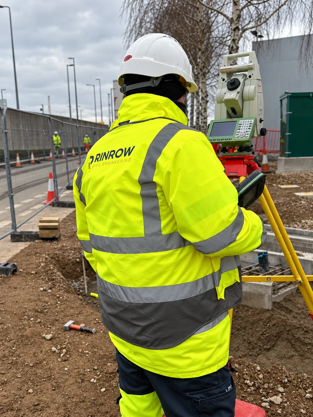 RINROW surveyor operating a total station on site