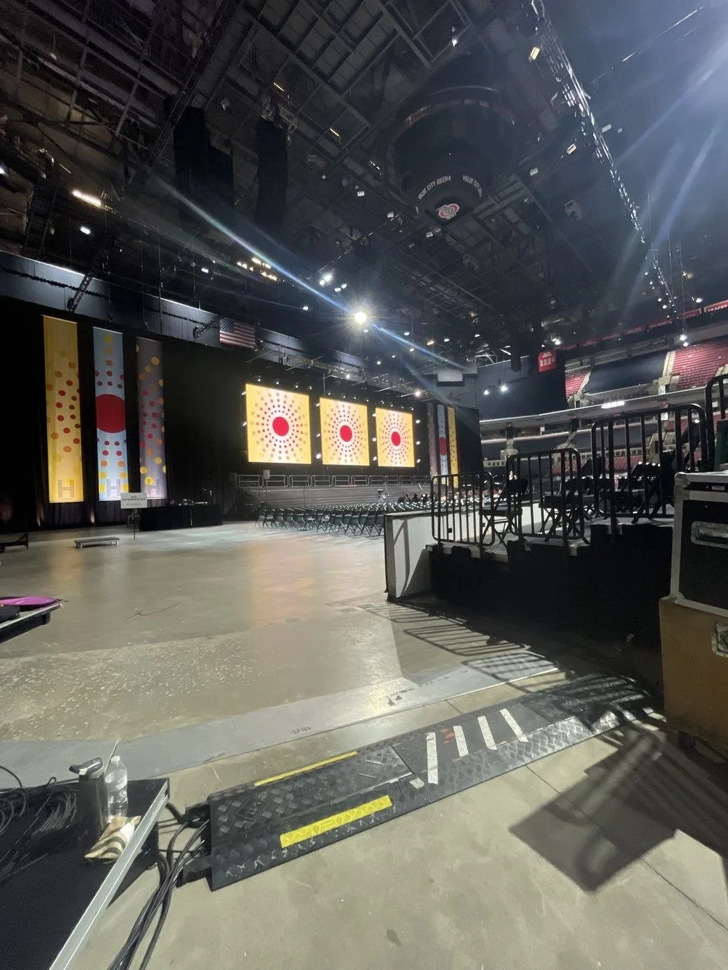 Value City Arena in Columbus, Ohio, set for a ceremony with three LED video walls, banners and stage lighting