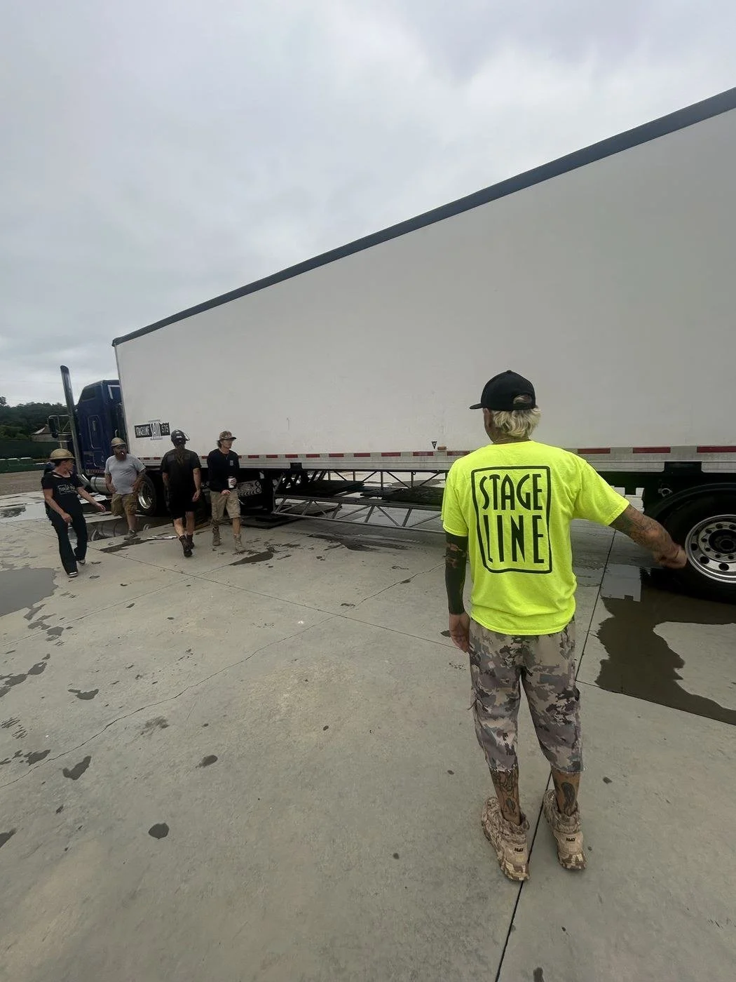 Stagehands walking to a mobile stage trailer to start a load-in