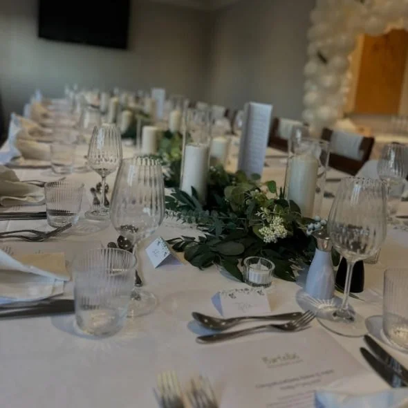 The Salon table dressed with greenery and candles
