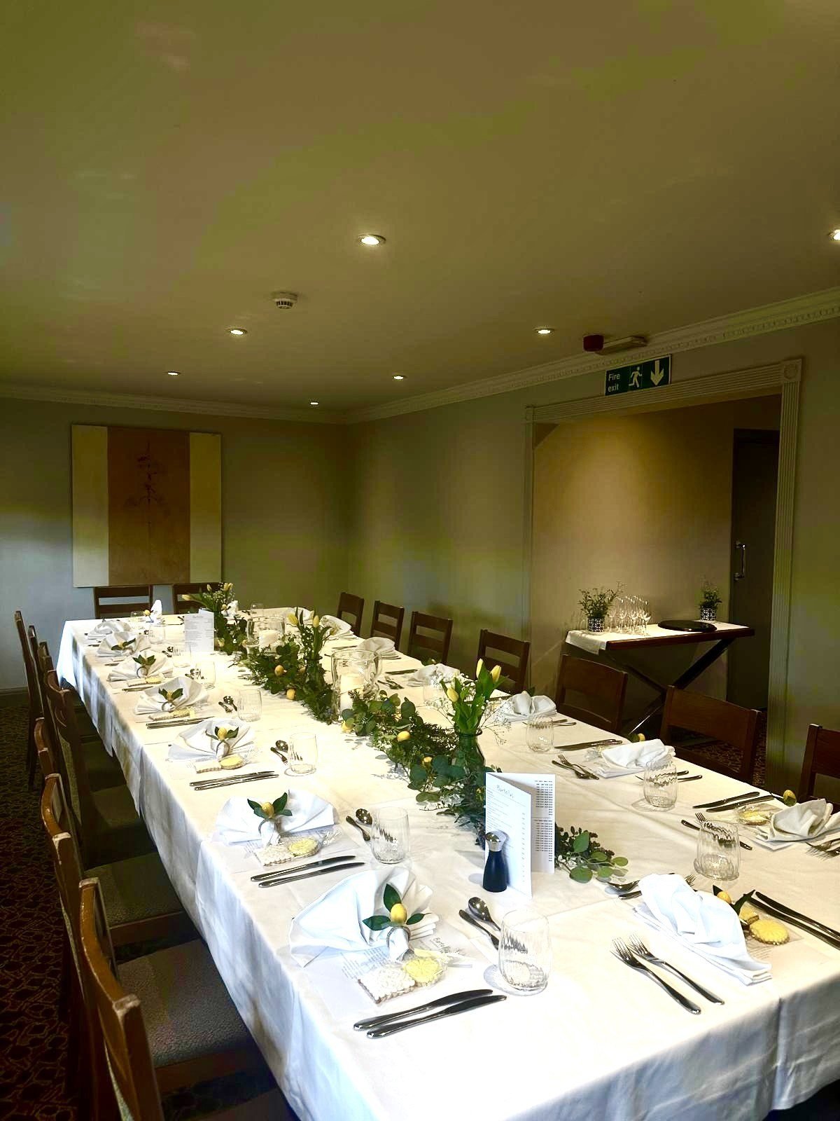 The Salon laid for a party, one long table in white linen