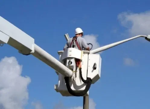 Electrician working from a bucket truck