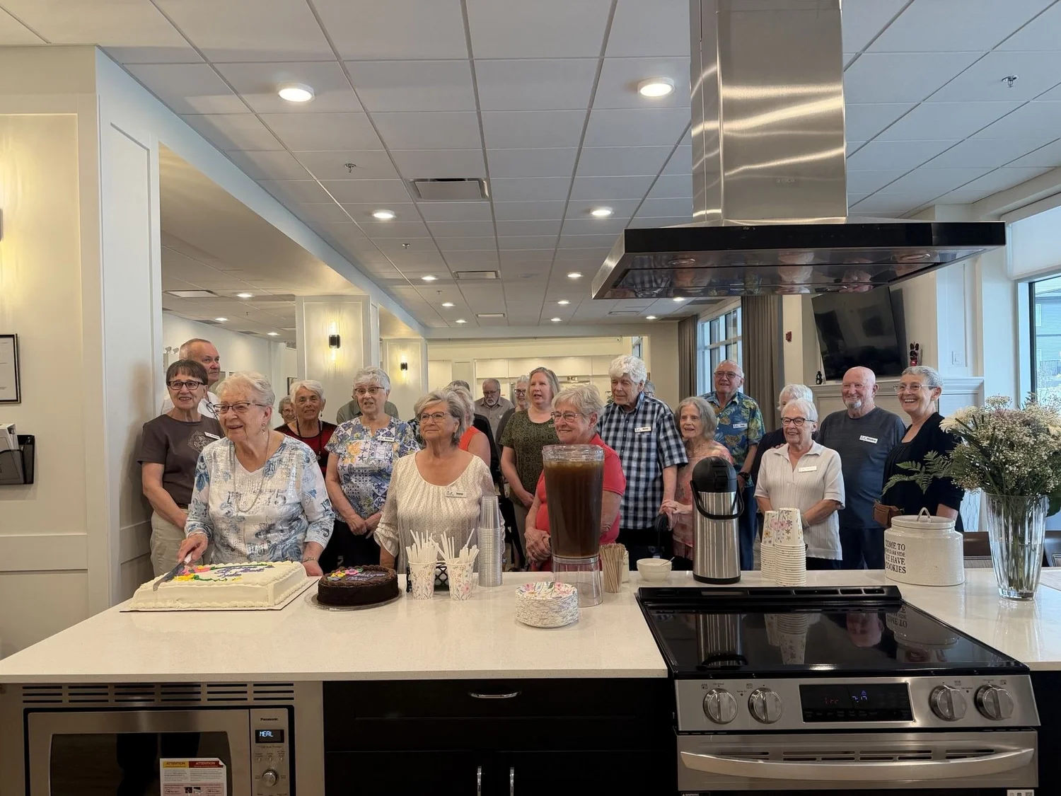 Neighbours gathered around the demonstration kitchen at Three Robins
