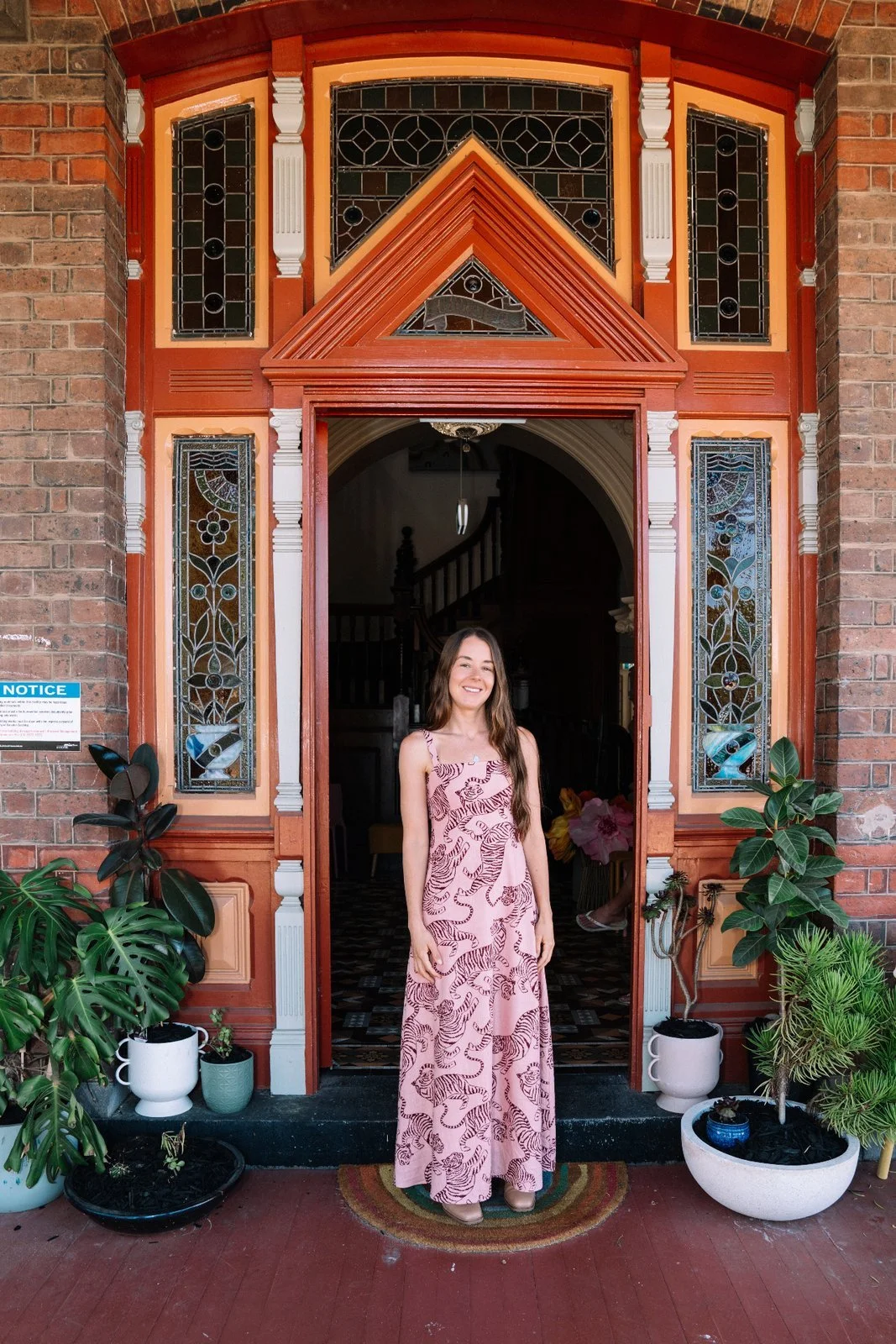 Bri Dunn, child and family therapist, welcoming you at the doorway of Ariston House in Newtown, Geelong