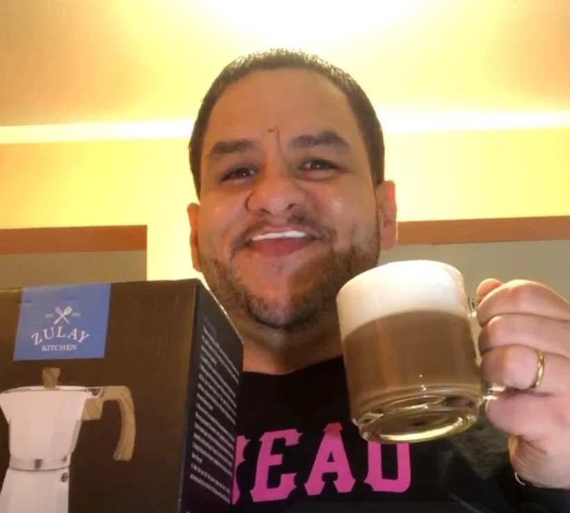 Louie live on Coffee Time in his Bronx apartment, smiling with a milk mustache and a frothy latte