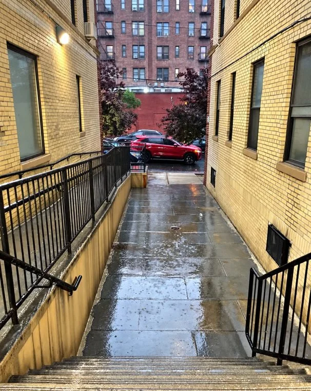 A rainy walkway outside Louie's old building in the Bronx