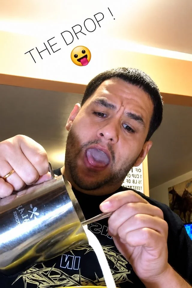 Louie doing the Froth Drop live, tongue out, pouring the froth