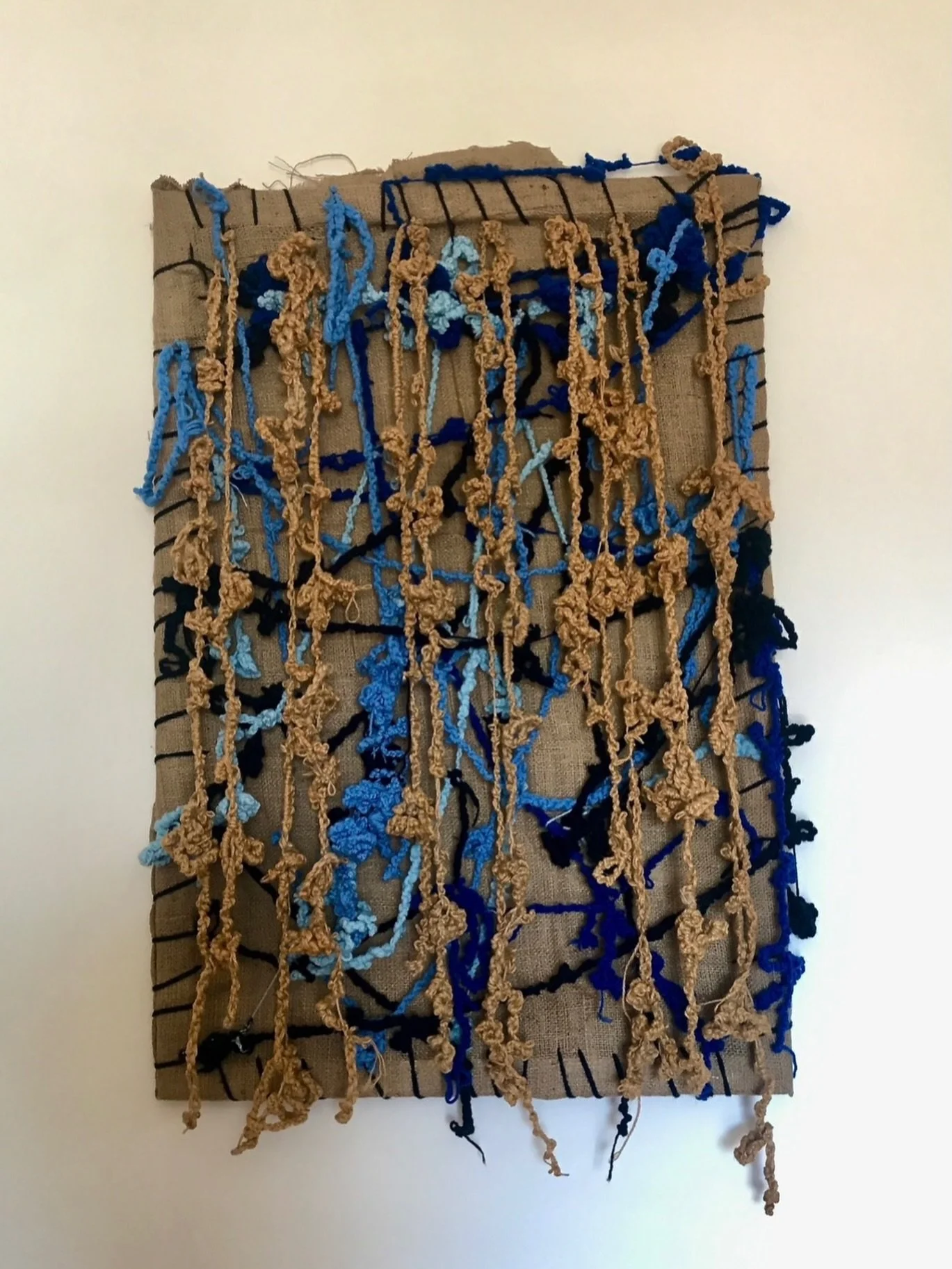 Su Taşkın’s work from her 2023 solo exhibition, blue and ochre knotted threads across a surface