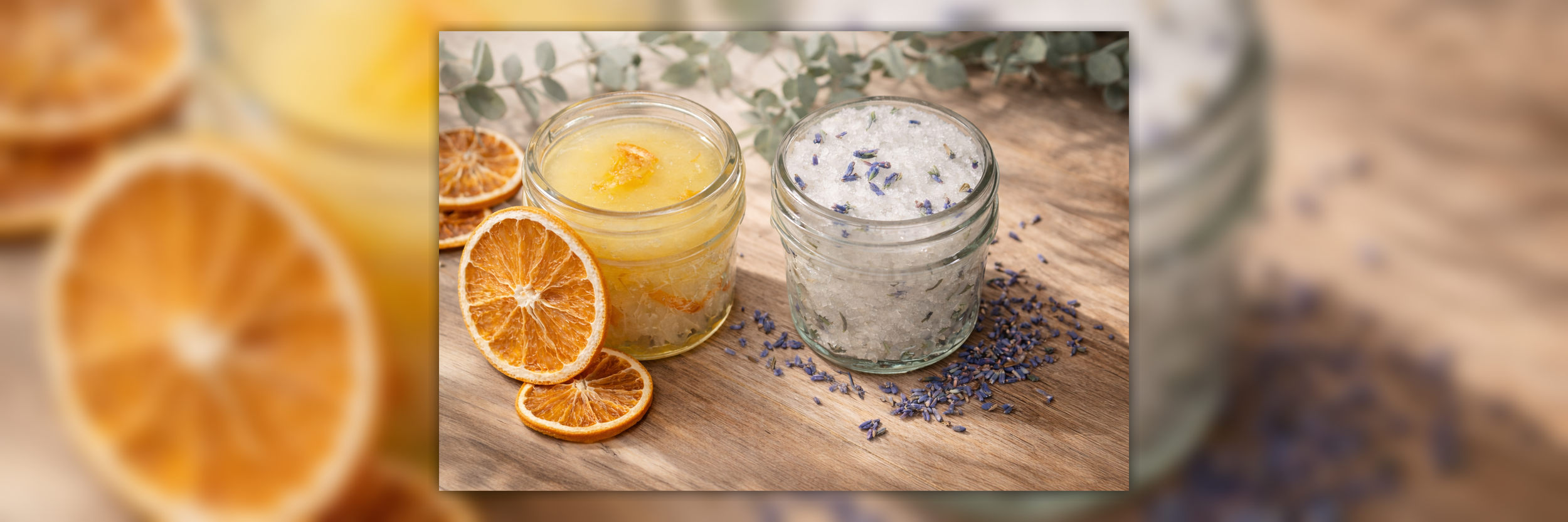Two open jars on a wooden surface, with orange slices and lavender-colored buds.
