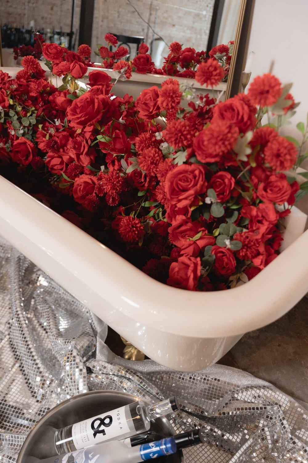 Clawfoot bath overflowing with red roses