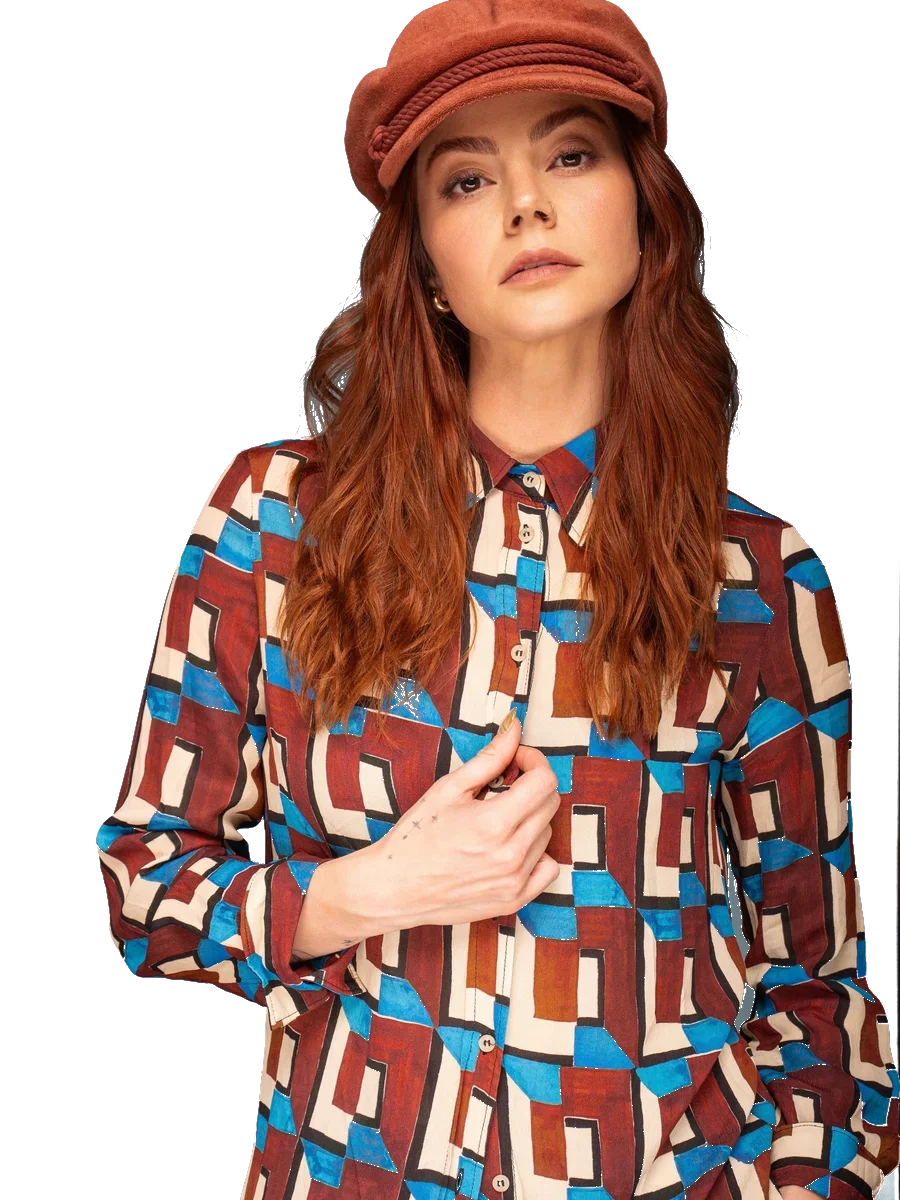 Kelsie Vanstone in a rust newsboy cap and a geometric-print shirt.
