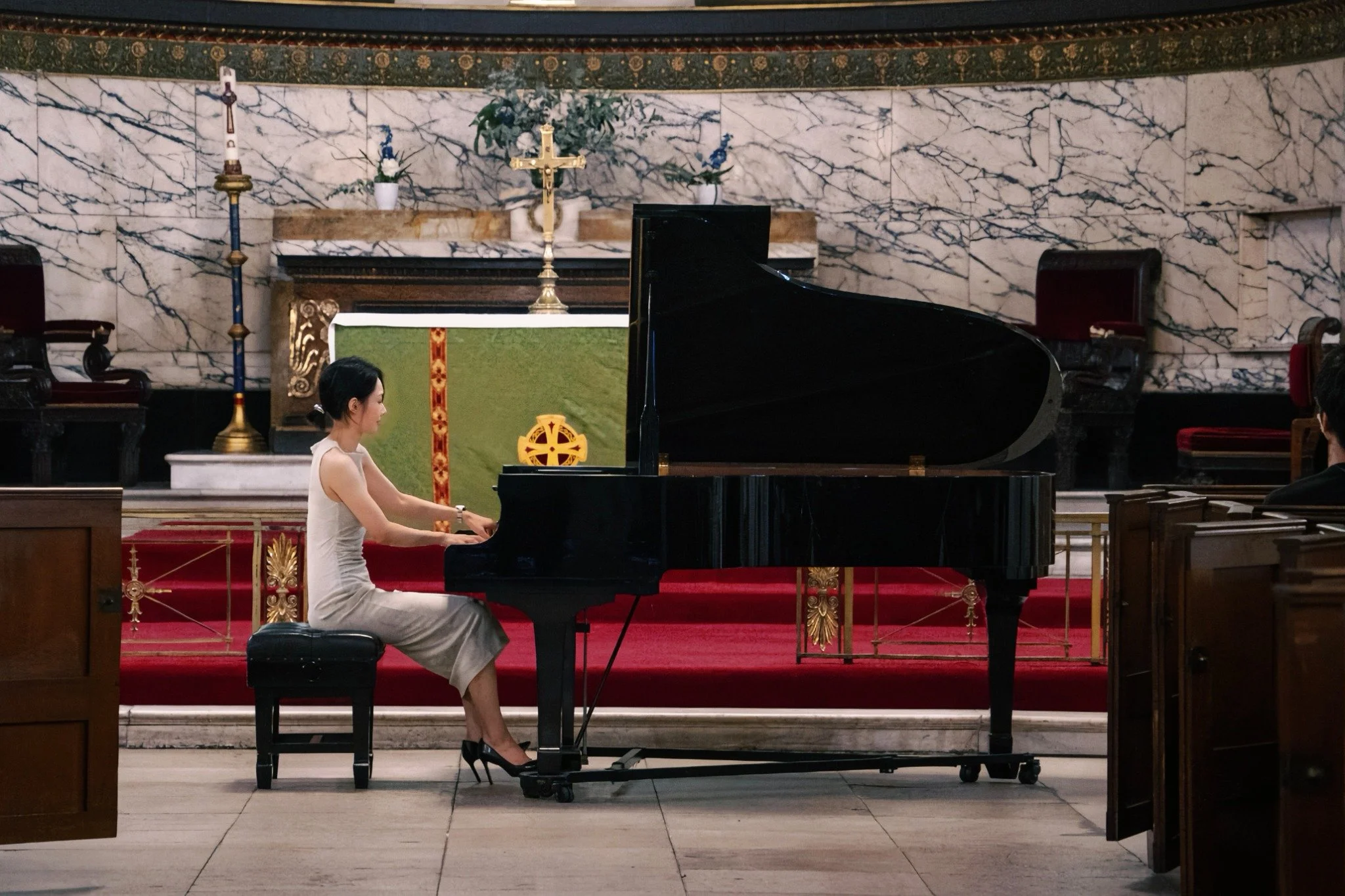 Shihua Liu performing at the grand piano in St Pancras Church, London