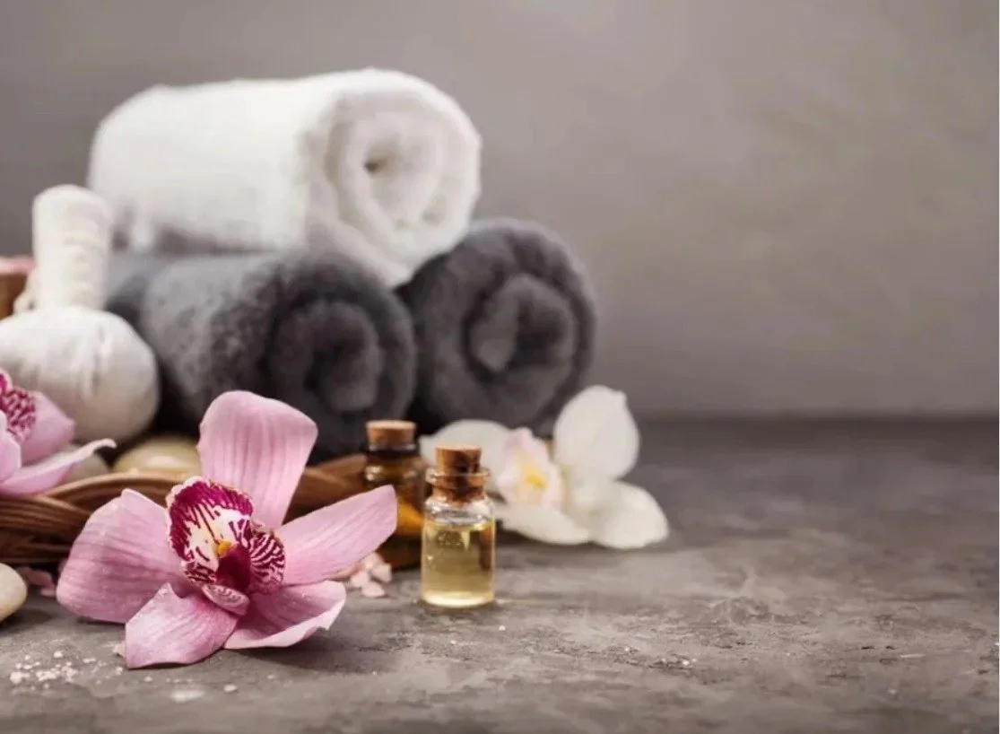 Rolled towels, massage oils and an orchid at W Spa in Palo Alto