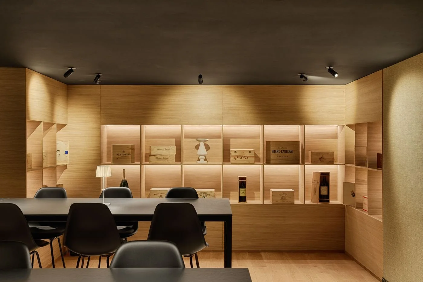 The tasting room with wine crates on oak shelves