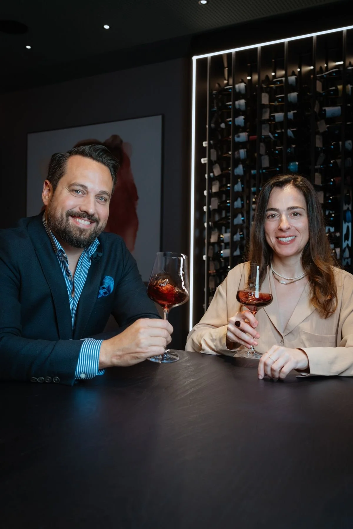 Martin Zuan and Anna Amanatidou, your hosts, with glasses of red wine in the lounge
